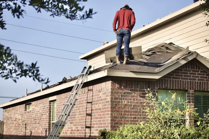 Professional roofer working on a residential roof in Jerico